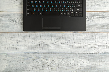 laptop on vintage shabby white wooden background. the view from the top. flat lay © AJ_stock_photos