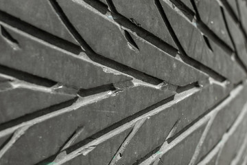 The texture of the used rubber tire. Car tire tread pattern