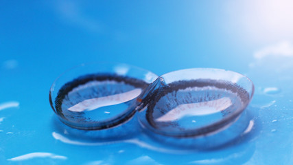 Contact colored lenses on a blue background, macro