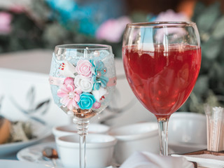 Two glasses of champagne on the background of the wedding bouquet of pink roses. Soft focus, selective focus