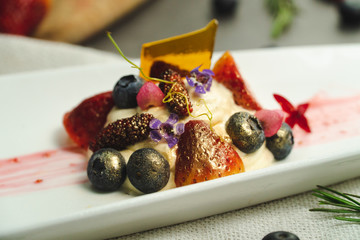 Dessert whip cream topping buy many fruit strawberry blueberry and raspberry set on white plate on cement background