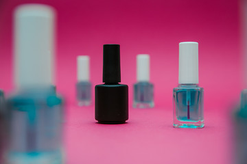 varnishes for nails on a red background in different compositions