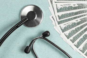 Stethoscope and money, concept. Paid medicine. Costs for the medical insurance