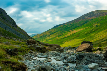 Stream running down the valley in a long exposure photo - Lake District, United Kingdom