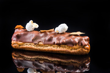 French Artisan Eclair on Black Reflective Background,Copy Space