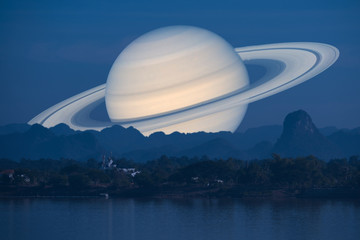 Saturn planet back silhouette river and mountain inght sky background