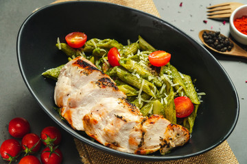 Food shot pesto pasta with grilled chicken breast