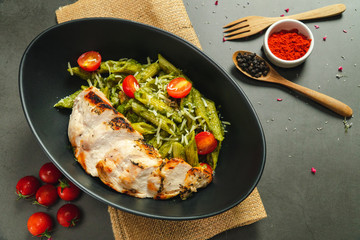 Food shot pesto pasta with grilled chicken breast
