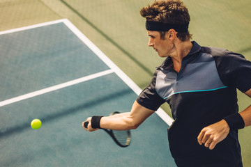 Professional tennis player hitting forehand © Jacob Lund
