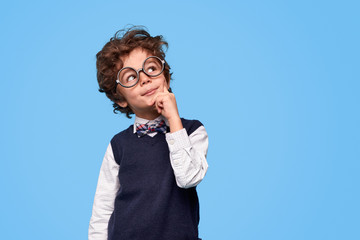 Thoughtful little genius looking up