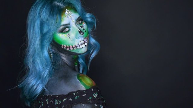 delightful image of dead mermaid, sugar sweet skull in cold colors, lady with bright blue hair in dark room, playing with voodoo magic and otherworldly spirits, place for text on black background