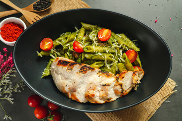 Food shot pesto pasta with grilled chicken breast