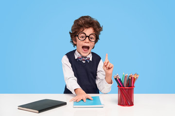 Amazed schoolboy having idea during studies