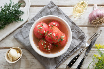 Marinated peeled tomatoes with garlic and dill, fresh ready to serve.