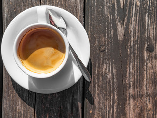 cup of coffee on wooden background. White ceramic cup, stylish toning, copy space