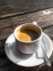 cup of coffe, image shape from shadow Yin Yang, on wooden background. White ceramic cup, stylish toning, copy space
