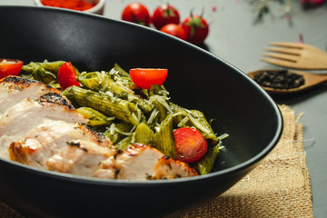 Food shot pesto pasta with grilled chicken breast