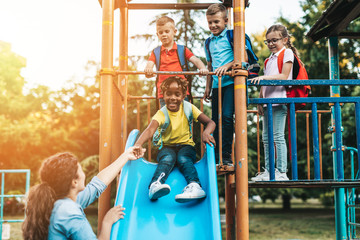 School children playing on the slide.