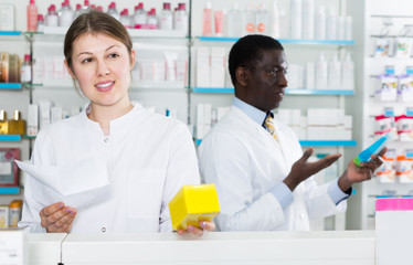 girl pharmacist picking up prescription medicines