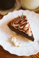 Dark chocolate pie whipcream and shiba inu toy decoration white dish on wood table