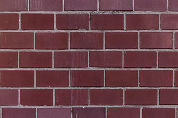 Obraz premium Old burgundy tile on the wall, rustic background.