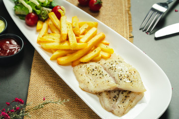 Food shot grilled fish fillet with potato chips