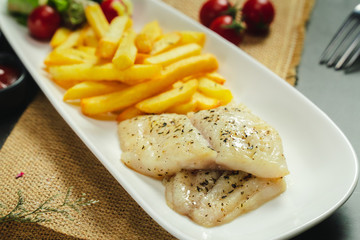 Food shot grilled fish fillet with potato chips