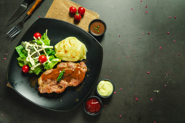 Food shot pork steak with mashed potato and salad