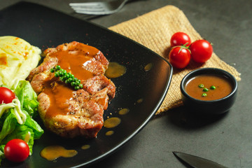 Food shot pork steak with mashed potato and salad