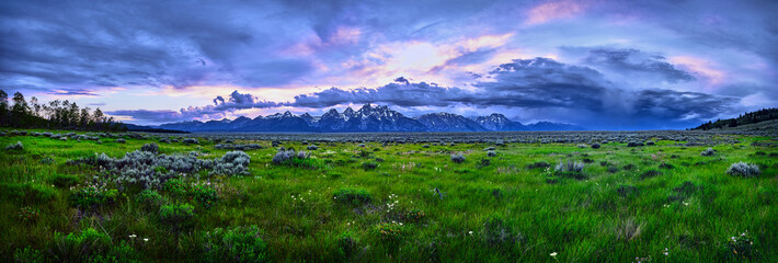 Panoramic image of a thunderstorm over the Grand Teton mountain range.