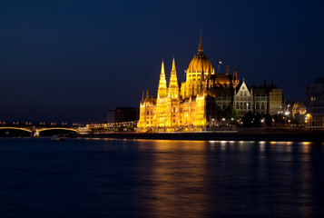 Fototapeta na wymiar View of the Danube river and the Parliament building on the embankment at night, Budapest, Hungary