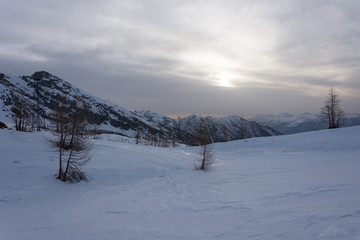 Obraz premium Snowy panorama of the Val Bognanco that opens behind Domodossola at the dawn, Piedmont