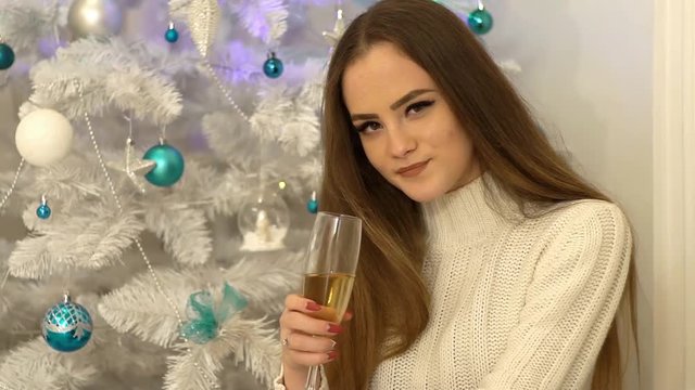 Girl With A Glass Of Champagne On The Background Of The Christmas Tree.