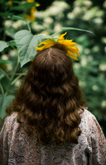 Young woman smelling sunflower 