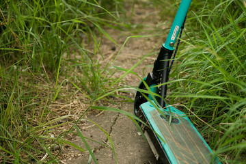 Electric scooter parked on grassy pathway