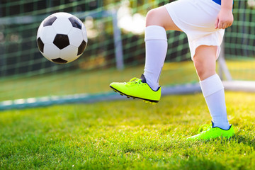 Kids play football. Child at soccer field.