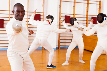 African american man fencer in training room