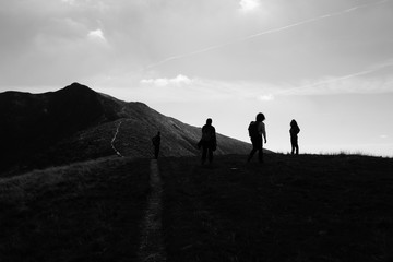 idyllic landscape at Monte Tamaro in Switzerland - silhouette of people