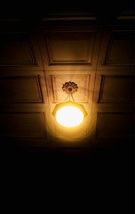Fototapeta na wymiar Vertical glowing lamp in total darkness object background hd