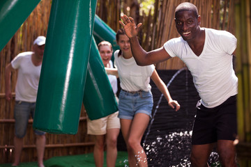 Obraz premium People passing horizontal bar at adventure park