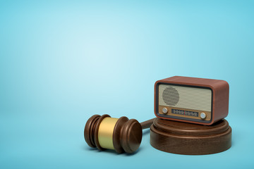 3d rendering of retro radio set on sounding block with brown gavel lying beside on light-blue background with copy space.