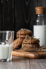 Chocolate chip cookies and milk on wooden background