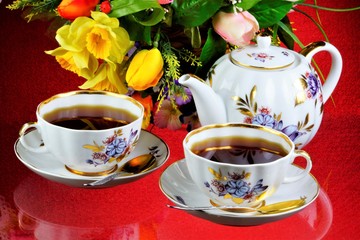 Tea party - tea in cups, teapot, garden flowers on a summer day. Daily tea is a delicious, popular, healthy, invigorating drink for Breakfast, lunch, dinner-brewing, infusion of a leaf of a tea Bush.