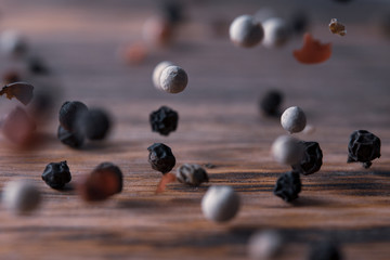 pepper mix falling on a wooden table