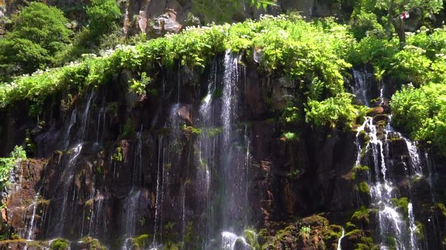 waterfall in a tropical forest on a sunny hot day. Georgia, waterfall Dashbashi. slow motion