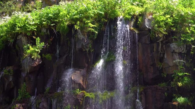 waterfall in a tropical forest on a sunny hot day. Georgia, waterfall Dashbashi.