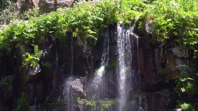 waterfall in a tropical forest on a sunny hot day. Georgia, waterfall Dashbashi.