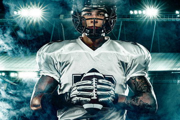 American football player, in helmet on stadium. Sport action concept.