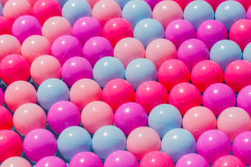 PRAID, ROMANIA - July 4, 2019: Plastic balls of various colors perfectly line up in several rows. Concept, symbol for unity, perfection, diversity, alginment, being different. Background, wallpaper.