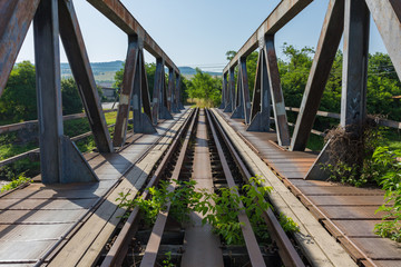 Fototapeta premium ODORHEIU SECUIESC, ROMANIA - Jul 2, 2019: Straight view over massive bridge with steel support on each side. Railways tracks. Symbol / concept for connection, communication, direct, peace, consequence
